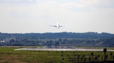 Pistten kalkan bir uçak. Ön planda, PAPI sinyal ışıklandırması