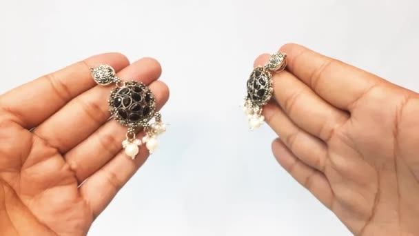 Vintage Pearl Metal Black Stone Earrings Male Two Hand Showing — Stock Video