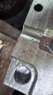 Atölyedeki bir makineyle metali kesme işlemi.