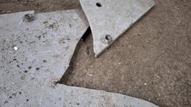 Kırık metal plaka, beyaz ve gri arkaplan.