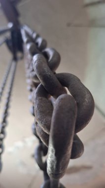 Duvarın arka planında eski metal zincir