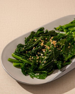 Masada Asya Çin yemeği var, tek kişilik. Sarımsaklı kızarmış bebek kailan. vejetaryen yeşil yemek.