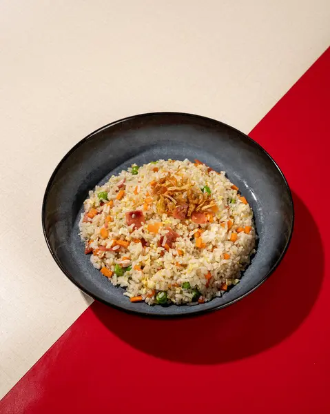 Fried rice is a dish of rice fried in a pan which produces a different taste because it is mixed with spices such as certain spices and sweet soy sauce.