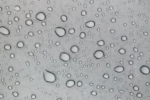 Stock image Raindrops on a gray tent canvas