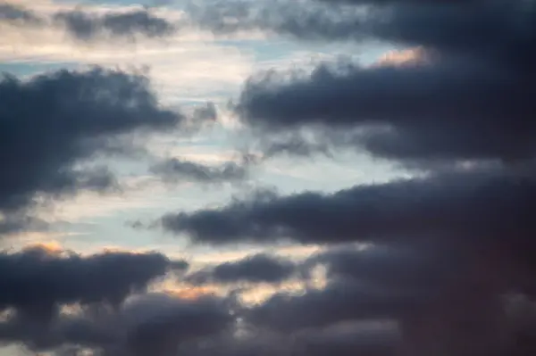 stock image Deep dark blue clouds against blue morning sky