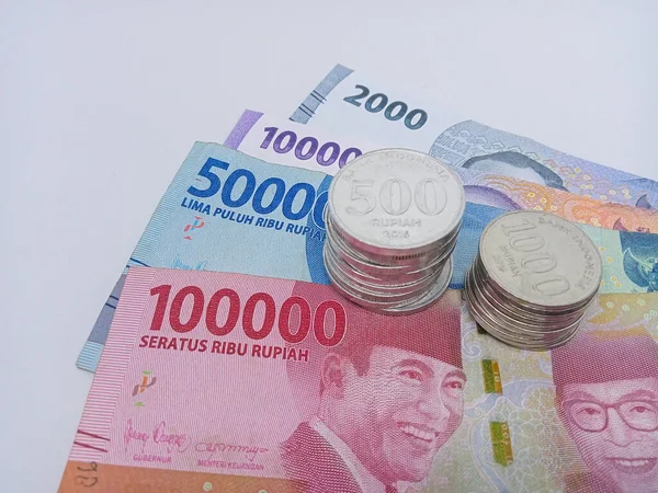 Indonesian currency, rupiah money paper and coin. One hundred thousand, fifty thousand, ten thousand, and two thousand nominal isolated on a white background.