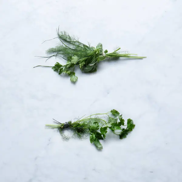 Aromatic Herbs, Isolated on Marble Background  Bunch of Basil, Parsley, Fennel Twigs from Italy, Bundled with Twine on Stone Kitchen Table  Detailed Close-Up Macro, High Resolution, Top View