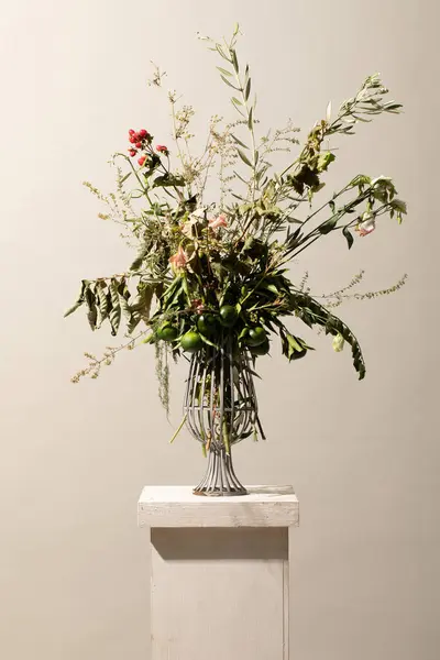 flower arrangement, with elements of the Mediterranean garden, Lesser Calamint, olive, lemon, vite leaves, pure decadent flower composition