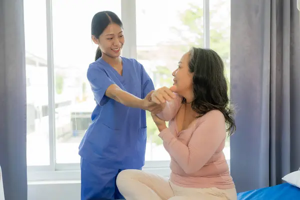 Elderly Female Patient Asian Female Physical Therapist Holding Her Arm — Stock Photo, Image