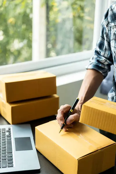 Asian business owners sell products on websites and online platforms and package the products for delivery to customers through courier services. SME business concept Close-up pictures