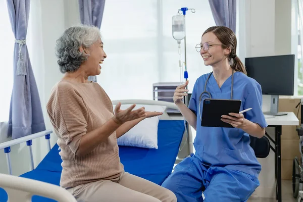 Female Doctor Clipboard Talking Elderly Female Patient Hospital Senior Woman — Stock Photo, Image