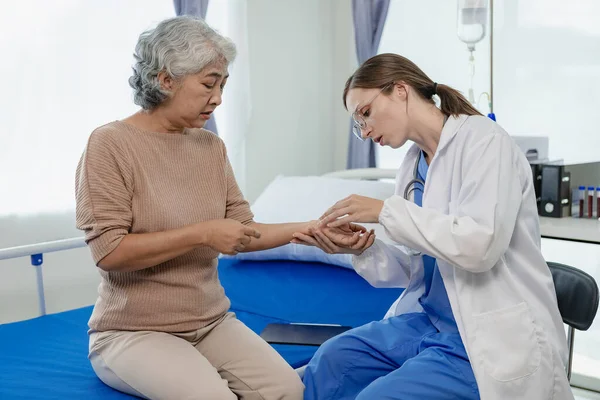 Female doctor with clipboard talking with elderly female patient at hospital Senior woman or doctor with digital tablet Consult or plan treatment to treat medical professionals with female patients.