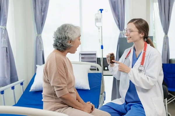 Female doctor with clipboard talking with elderly female patient at hospital Senior woman or doctor with digital tablet Consult or plan treatment to treat medical professionals with female patients.