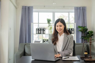 Asya ofisinde dizüstü bilgisayarlı danışman, özel bayan avukat online hukuk danışmanı sözleşmeli belgeler üzerinde çalışan eleman.