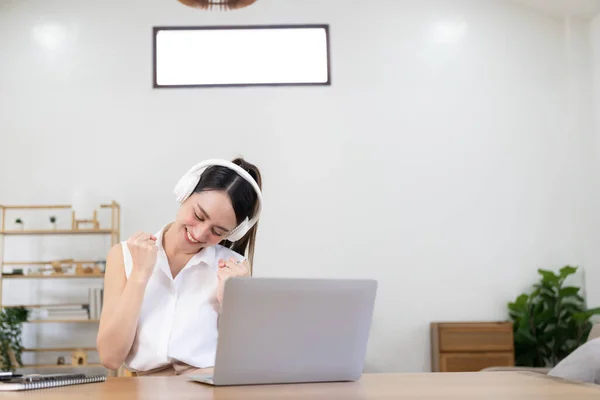 Glimlachend Aziatisch Meisje Met Een Koptelefoon Een Laptop Het Scherm — Stockfoto