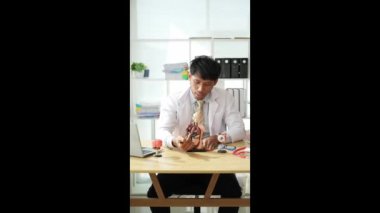 Genç doktor, internetteki iç organların işlevlerini, tıbbi sağlık konseptini açıklıyor. Dikey video