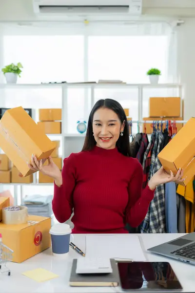 Eco-friendly packaging boxes in Asian stores, home retail, small SME owners, working people, Asian women, Gen Z, happy people, smiling proudly. Vertical image.