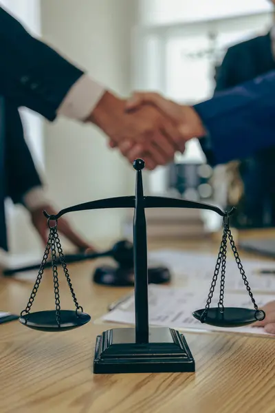 Lawyer shaking hands with businessman Investors in financial deals The duo congratulated them on their success. Or the lawyer is discussing a contract. Close-up pictures.