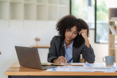 Ofiste başı ağrıyan yorgun bir iş kadını iş yerinde kendini hasta hissediyor çok çalışıyor ve çok geç, ofis sendromu kavramı..