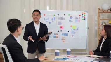 Bir grup iş adamı, finansal stratejiler hakkında konferans odasında dizüstü bilgisayarlarla beyin fırtınası ve pazarlama ve pazarlama analitik dokümanlarını tartışıyor..