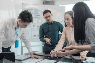 Bir grup iş arkadaşı konferans odasında çok yönlü modern ofiste toplanıyor: yöneticilerle yapılan iş toplantıları, konuşmalar, grafik sunumları, büyük veri dijital girişimcileri