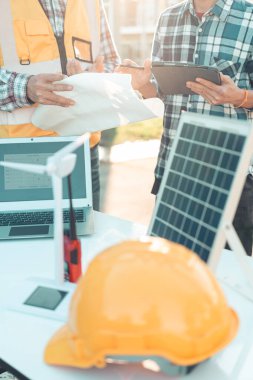 Mühendisler ve inşaat işçileri veya ev planları, konut binaları veya emlak veya mimari yenilik ofisleri. İnşaat alanındaki insanlar, yakın çekim..