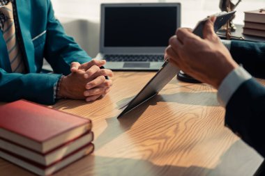 Avukat ekibi, ofisteki müşteriye imzalı sözleşme belgesini sunuyor. Hukuk, yargıç, mahkeme, hukuk kavramı. Yargıcın adalet terazisiyle tokmağı. Kapat..