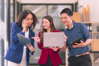 Takım çalışmasının sonuçlarını gösteren çizelge ve grafikleri tartışan bir grup iş stratejisi hakkında modern ofiste finansal verileri analiz eden bir grup iş adamı..