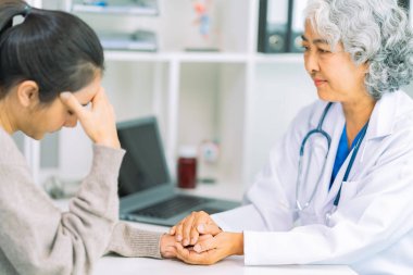 Doctor and patient discussing various matters while sitting at a table. Medical and healthcare concept. Doctor and patient.