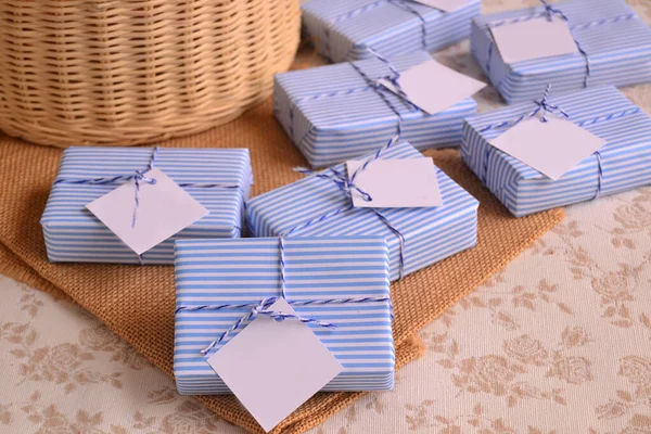 Stock image Guest favors small gifts baby boy shower first communion baptism souvenirs, nautical sailor style soaps packaging blue white striped paper ribbon, summer beach weddings presents decoration ideas 