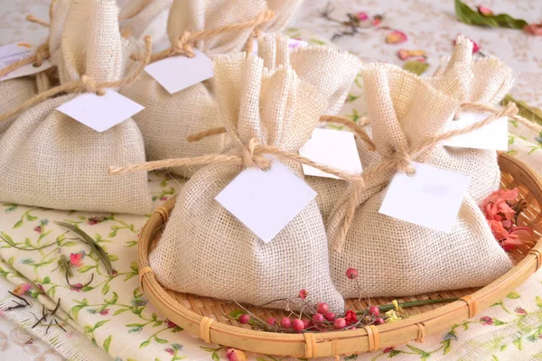 stock image Wedding favors details decoration white jute burlap bags package for guest gifts, original party souvenirs rustic shabby chic style reception, diy handmade ideas for small presents