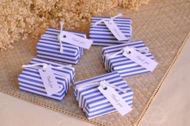 Summer beach wedding guest gift small boxes wrapped in sailor nautical style dark blue and white striped paper  whith cotton rope, beautiful packaging ideas, bridal party, baby boy shower, handmade soap  clipart