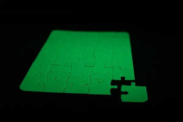 stock image Green puzzle with a corner missing puzzle to choose which piece fits in the hole puzzle with a corner missing. The missing piece is green