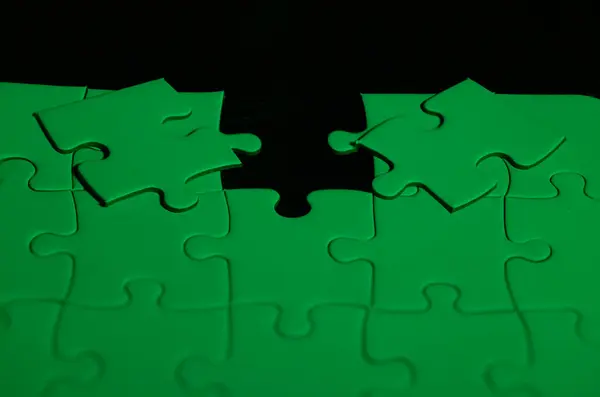 stock image Green puzzle with a red piece to choose which one fits in the hole puzzle to choose which piece fits in the hole