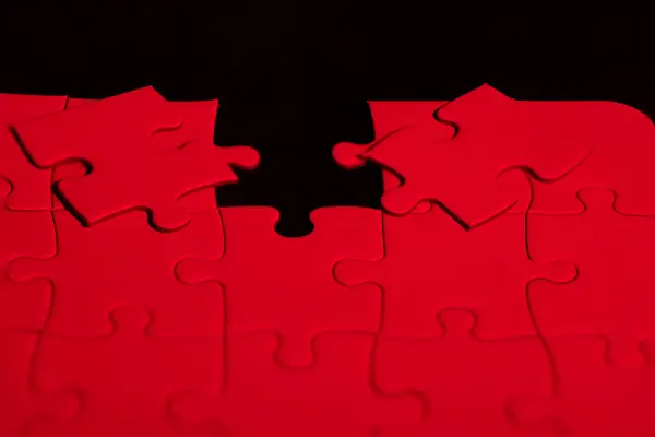 stock image Red puzzle to choose which piece fits in the hole