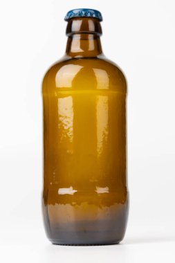 Tek bir kahverengi bira şişesi, dikey konumda ve merkezde, temiz beyaz arka planda sergileniyor. Minimalist tasarım şişenin basitliğini vurguluyor