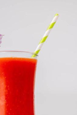 Detailed shot of a Bloody Mary cocktail with a green straw, positioned in the center of the horizontal frame. The stark white background emphasizes the vibrant colors of the drink clipart