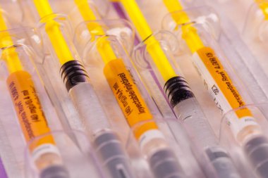 Pıhtılaşma önleyici solüsyonlu şırıngalar menekşe üzerine düzenli bir şekilde serili.