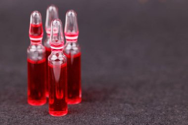 Tıbbi destek kullanımı için koyu arkaplanda kırmızı B12 ampulleri satırı