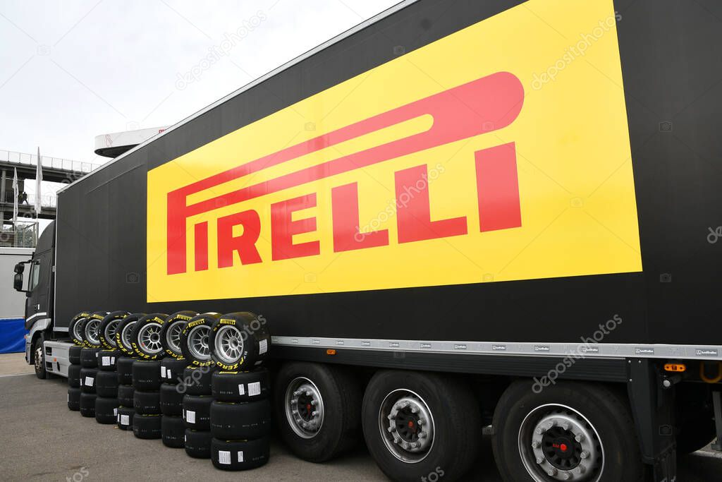 Scarperia, Italy, 21 October 2022 - Yellow Pirelli tires mounted on alloy wheels in front of the Pirelli truck in the paddock of the Mugello circuit during the ACI CSAI Racing Weekend 2022.