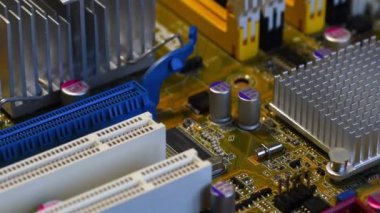 detail of the PCI (Peripheral Component Interconnect) and PCI Express (Peripheral Component Interconnect Express) slots on a modern PC motherboard.