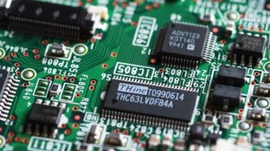 Florence, February 2023: Extreme Closeup of Printed Circuit Board with Electronic Components and Microchips in rotation. Italy