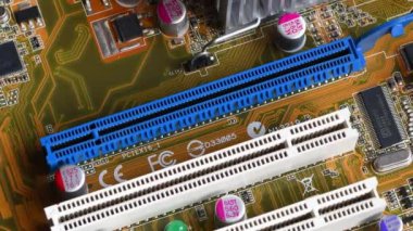 detail of the PCI (Peripheral Component Interconnect) and PCI Express (Peripheral Component Interconnect Express) slots on a modern PC motherboard.