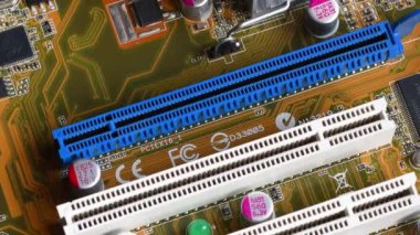 detail of the PCI (Peripheral Component Interconnect) and PCI Express (Peripheral Component Interconnect Express) slots on a modern PC motherboard.