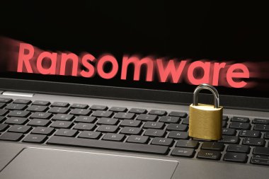 Computer security concept with a closed padlock on the laptop keyboard and 