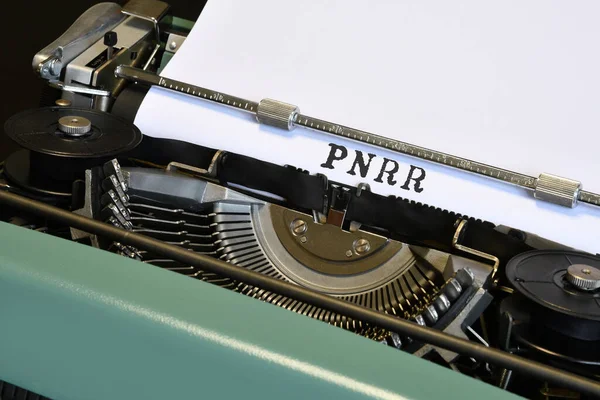words \'PNRR\' typed on vintage typewriter. The National Recovery and Resilience Plan is part of the Next Generation programme, that the European Union negotiated in response to the pandemic crisis Covid 19.