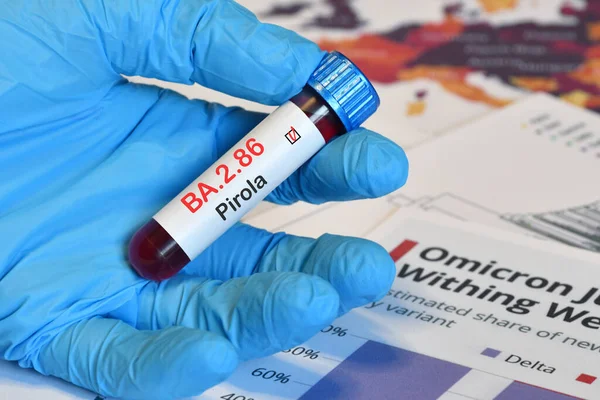 stock image Doctor holds blood test tube for the detection of the BA.2.86 Pirola variant of the Covid-19 virus on papers documents.