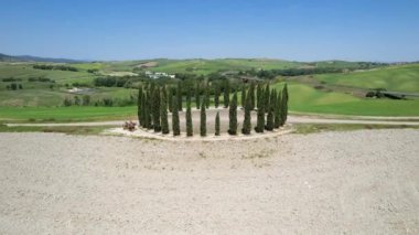 San Quirico d'Orcia, May 2022: Group Of Cypresses In Tuscany. Circular aerial view of cypress ring in Val D'Orcia. The location where they are located is known as the 