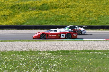 Scarperia, 5 April 2024: Maserati MC12 GT1 year 2005 in action during Mugello Classic 2024 at Mugello Circuit in Italy. clipart