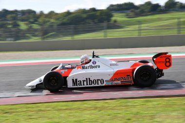 Scarperia, Italy - October 12th 2024: McLaren MP4/1B of year 1982 ex Niki Lauda drive by unknown in action during practice session at Mugello Circuit. clipart